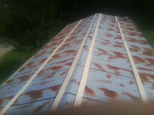 Rusted metal roof panels with new wood purlins before replacement — Storm Damage Roof Repair in Shokan by Roofing Brothers