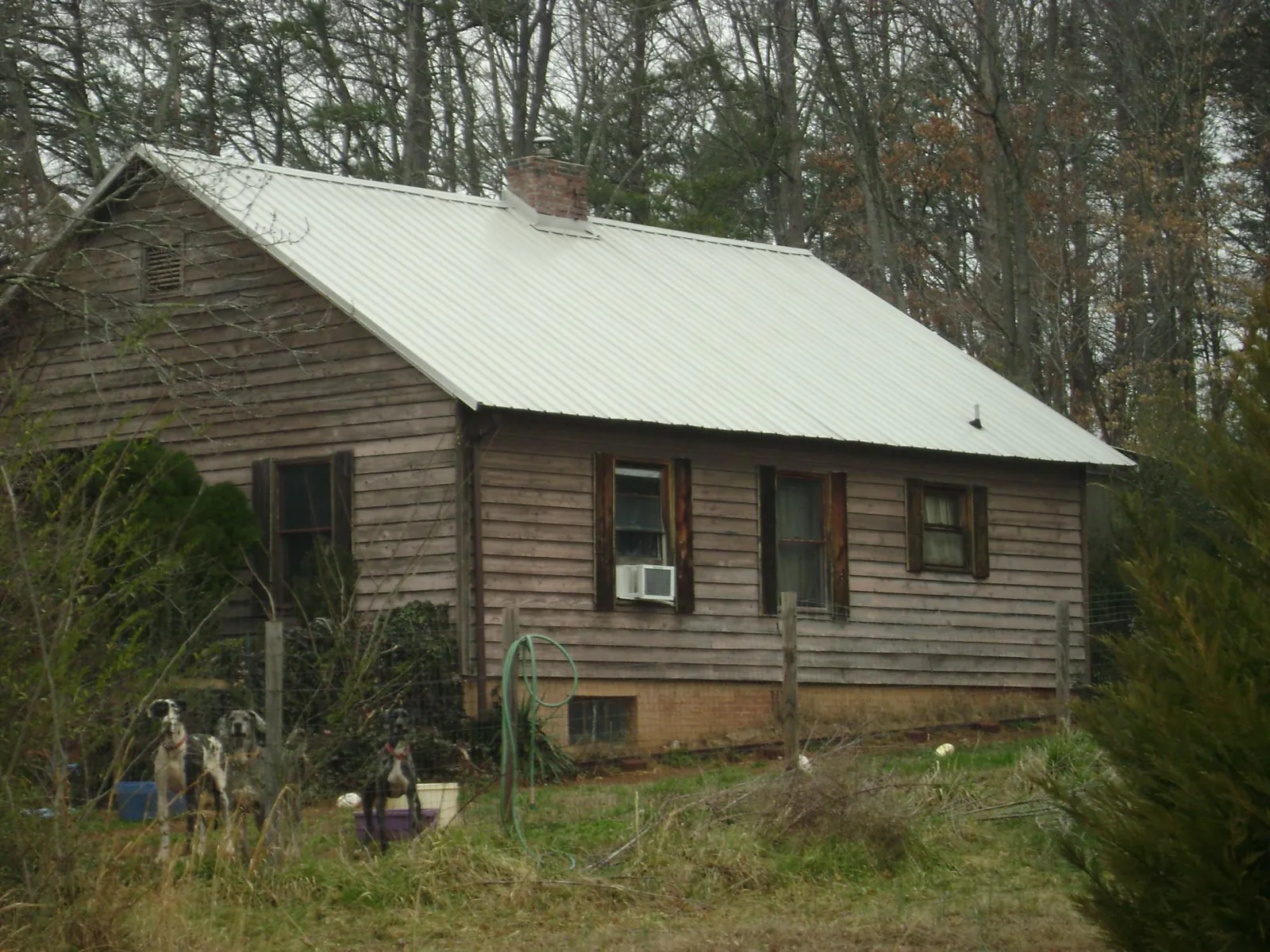 White metal roof on an old wood sided farmhouse, from a Metal Roof Installation job in Shokan